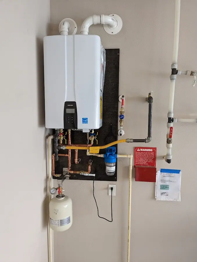 Professional plumber installing copper piping in a Rutherfordton home